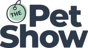 Logo with the words The Pet Show in large, bold letters. The is inside a green circular pet tag with a small loop, while Pet Show is written in dark blue, playful font to the right and below the tag.