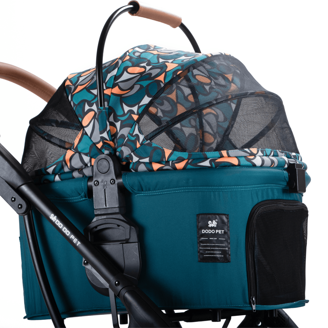 Close-up view of a teal pet stroller featuring a vibrant patterned canopy, detailed with a mesh cover and adjustable handle, emphasizing its stylish and functional design