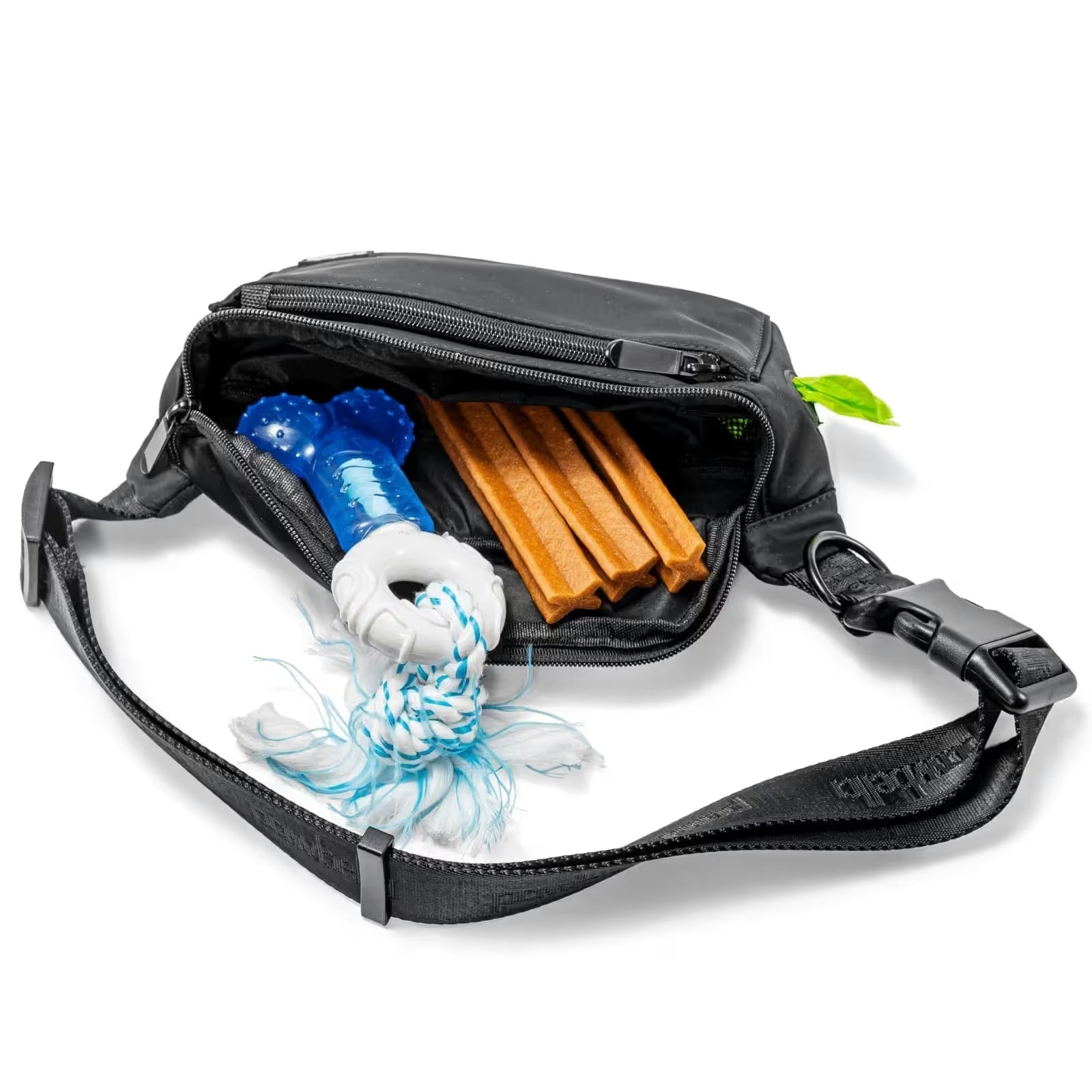 A Pawbella Dog Walking Bum Bag in black is unzipped to reveal a blue dog toy with white rope and three brown chew sticks inside, all shown on a white background.