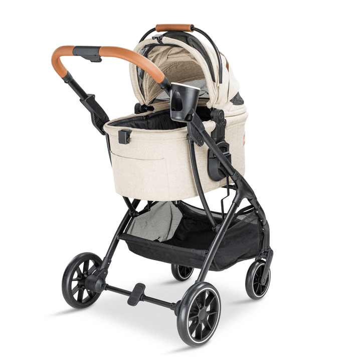 Rear angle view of a beige Pawbella pet stroller with an open canopy, leather-wrapped handle, and black frame, designed for stylish and convenient pet transportation.