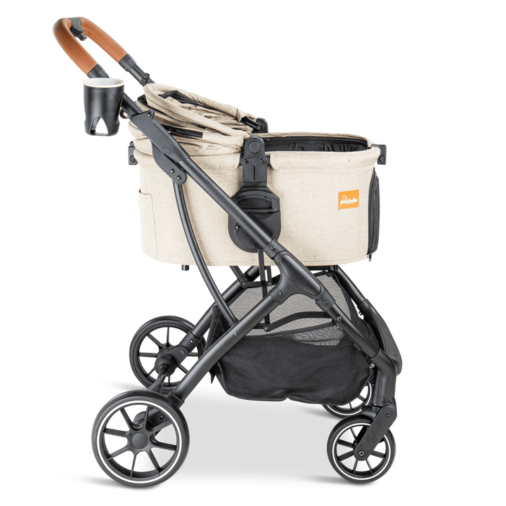 Side view of a beige Pawbella pet stroller with the canopy folded flat, featuring a sturdy black frame, mesh storage basket, and a cup holder, ideal for comfortable pet travel.