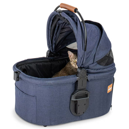 A cat sitting comfortably inside the detachable navy carrier of the Pawbella stroller with the canopy fully open.