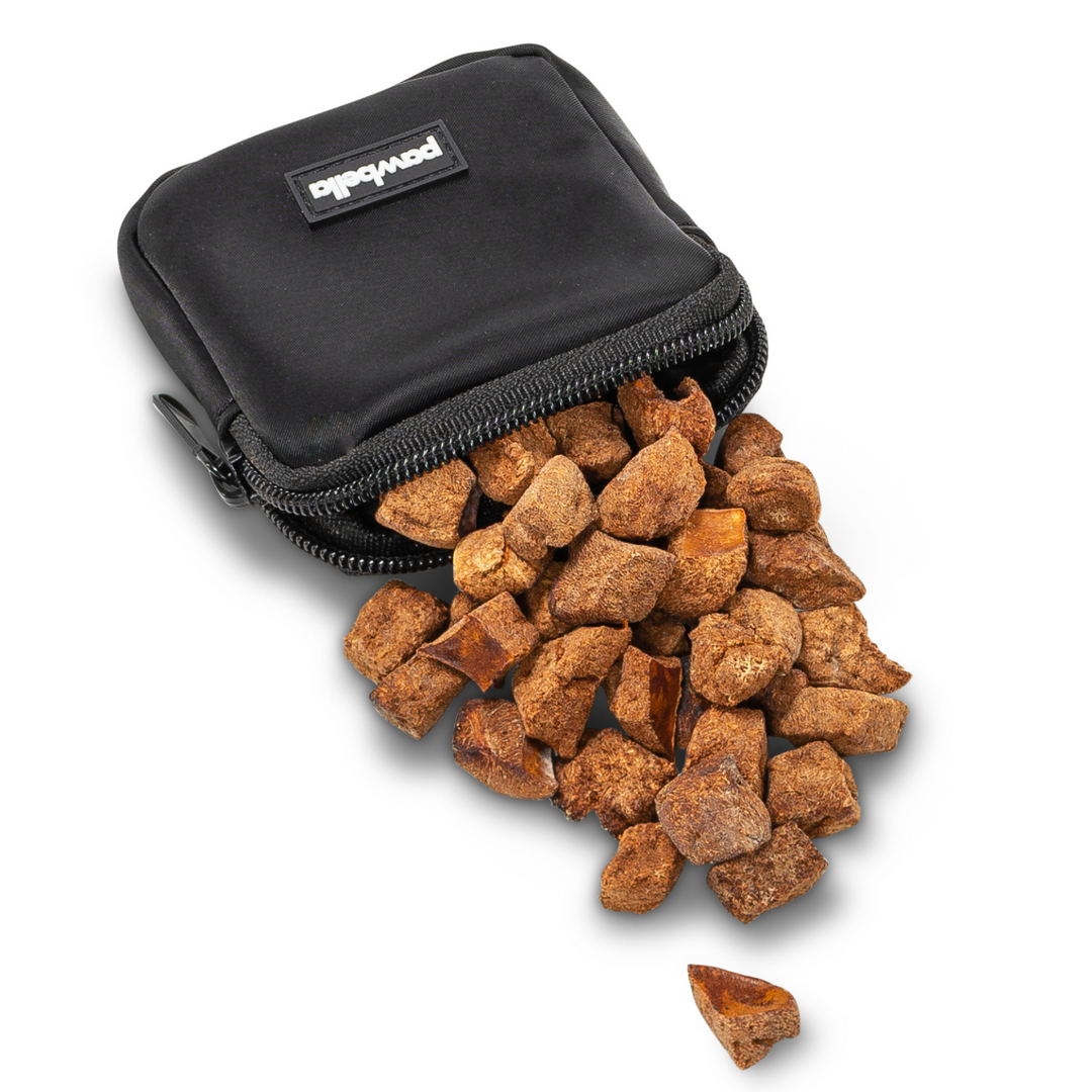 Black Pawbella treat pouch from the dog walking shoulder bag set, unzipped and filled with dog treats, designed for convenient snack storage during walks.