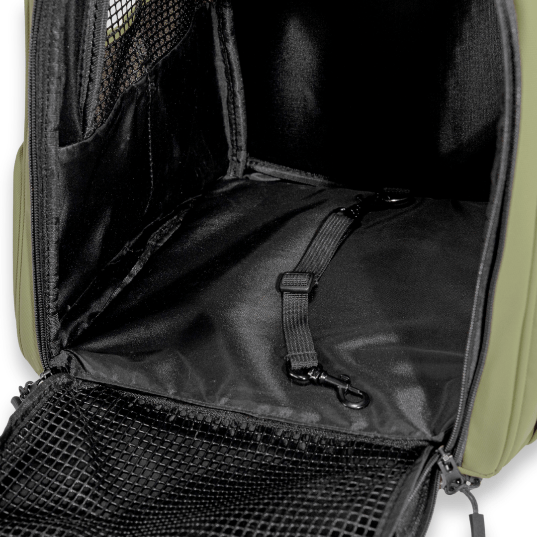 Interior view of an olive green Pawbella pet backpack, featuring a secure safety tether and spacious design with a breathable mesh window, ideal for safe pet travel.