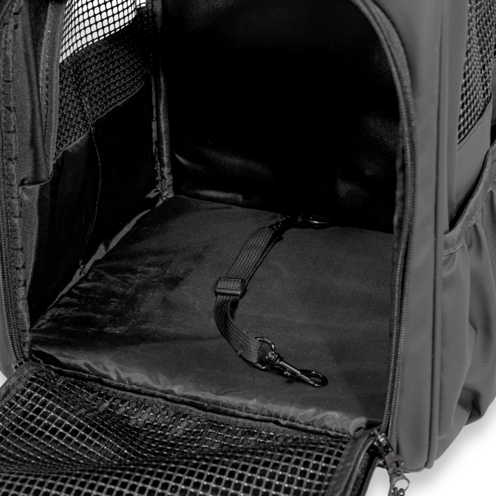 Interior view of a black Pawbella pet backpack featuring a safety tether clip, ensuring pet security with ample space and breathable mesh side panels.