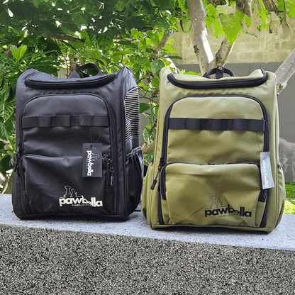 Black and Olive green Pawbella pet backpacks displayed together in Australian nature setting