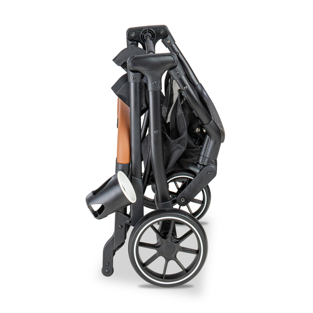 Upright, compactly folded frame of the Pawbella pet stroller with a leather-wrapped handle and cup holder, designed for easy storage and portability.