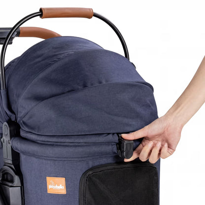 Close-up of a hand operating the quick-release front buckle on the Pawbella pet stroller canopy for easy access.