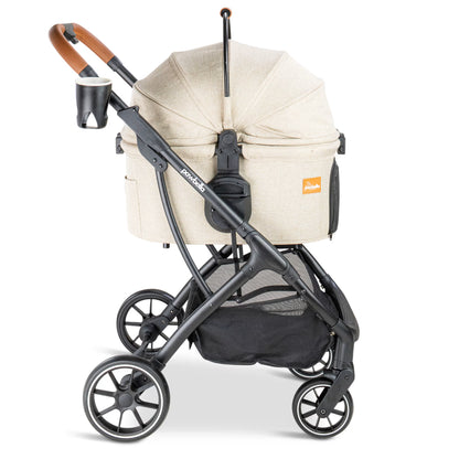 Side profile of the beige Pawbella Ultimate Pet Stroller featuring a matte black frame, cup holder, and detachable bassinet.