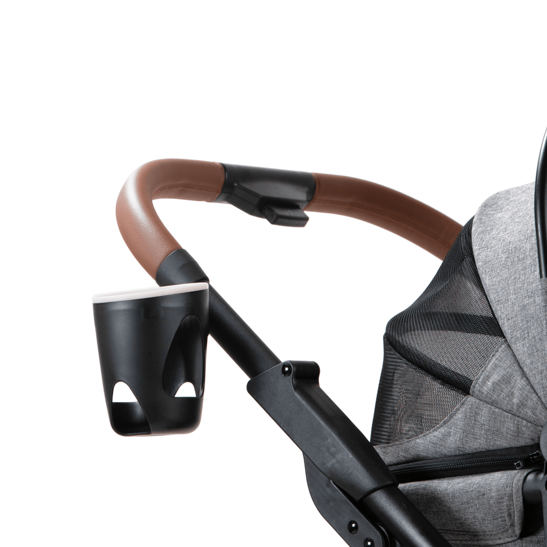 Close-up view of the handle and cup holder on a pet stroller, featuring a leather-wrapped grip and a black cup holder attached to a grey fabric stroller.